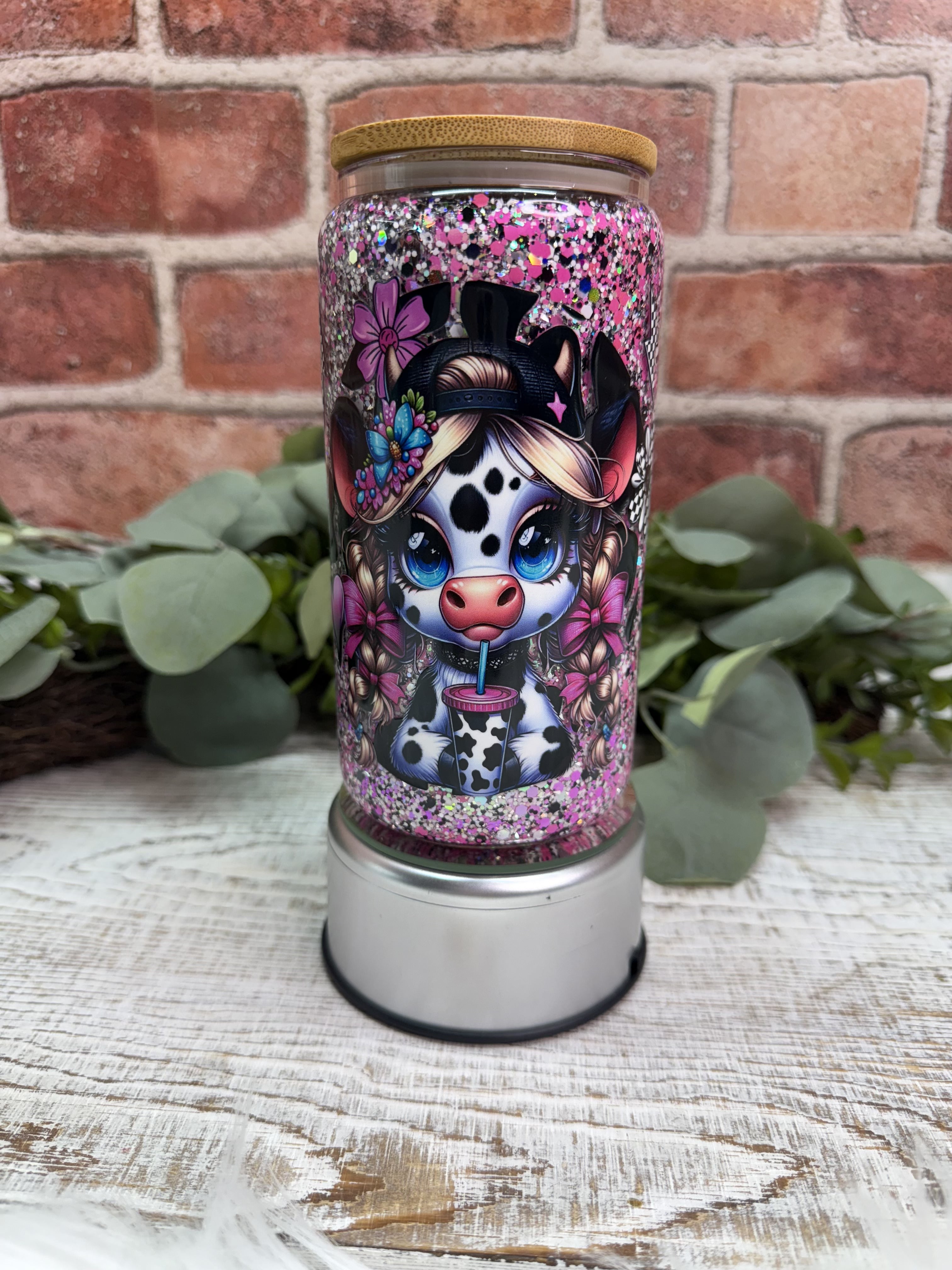 purple and black glitter, hearts, flowers, and lightning bolt decals tumbler