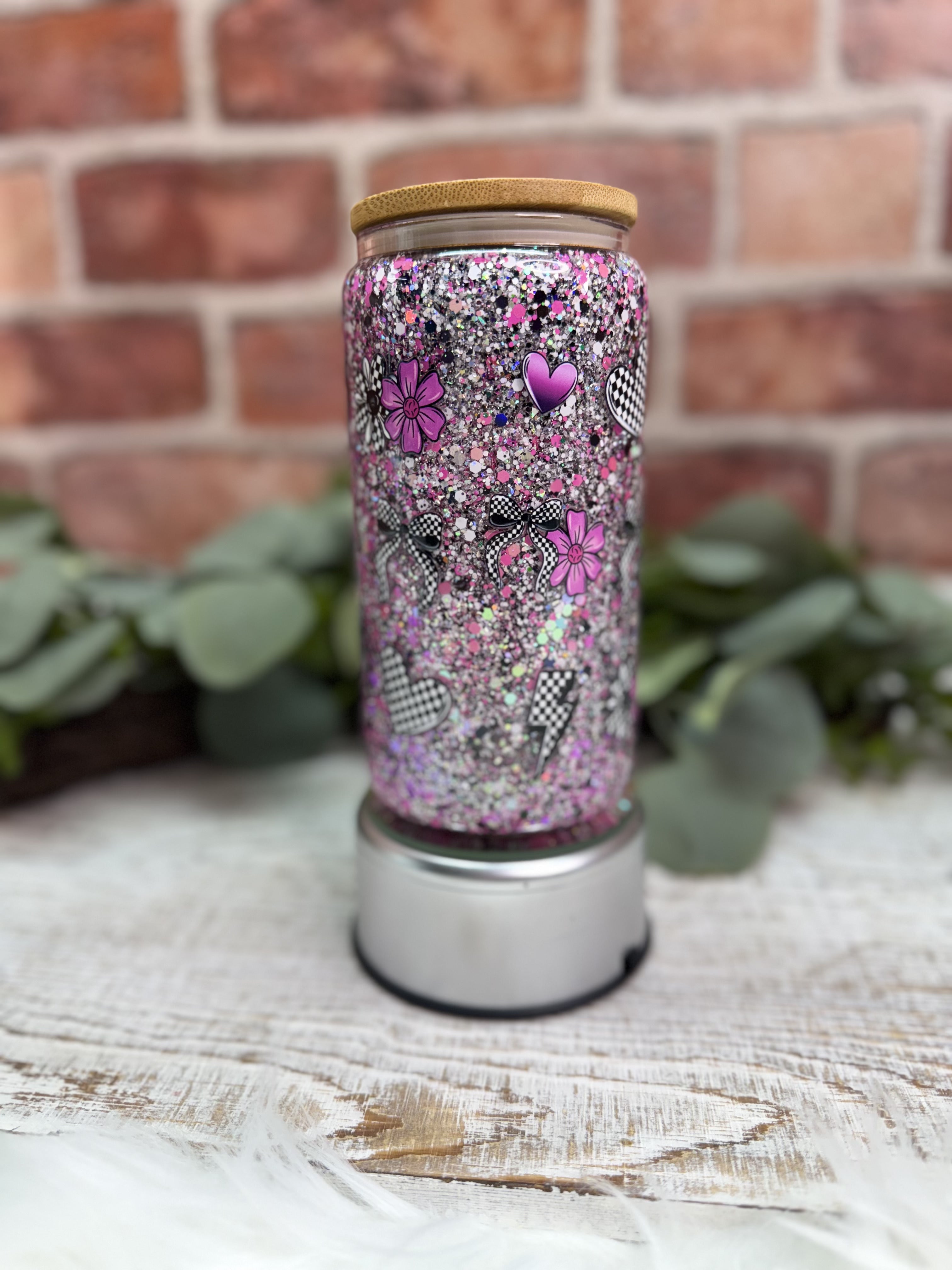 purple and black glitter, hearts, flowers, and lightning bolt decals tumbler